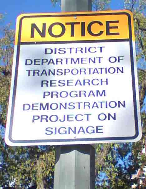 photograph of traffic sign in Washington, DC, that reads Notice District Department of Transportation Research Program Demonstration Project on Signage 
